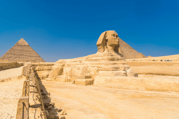 The Great Sphinx with pyramids in background