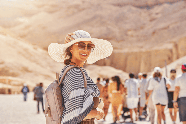 Woman smiling in a sunny desert setting.