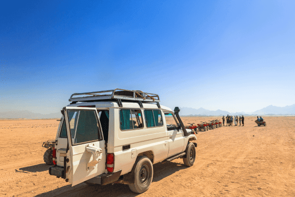 White 4x4 vehicle on a desert landscape