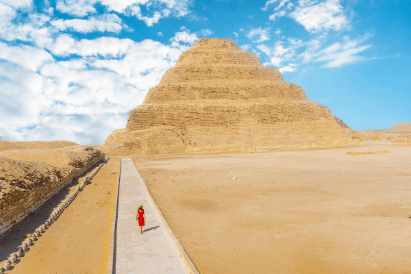 Person walking towards the Step Pyramid in Egypt.