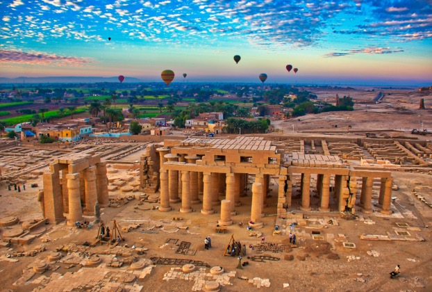 Hot air balloons over ancient Egyptian temple ruins