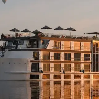 Luxury hotel boat with hot air balloons overhead
