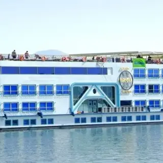 A cruise ship sailing on a calm river.